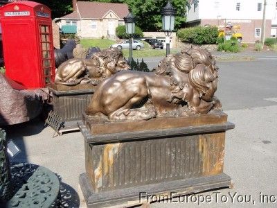 PAIR OF BRONZE LAYING LIONS ON MARBLE BASES  